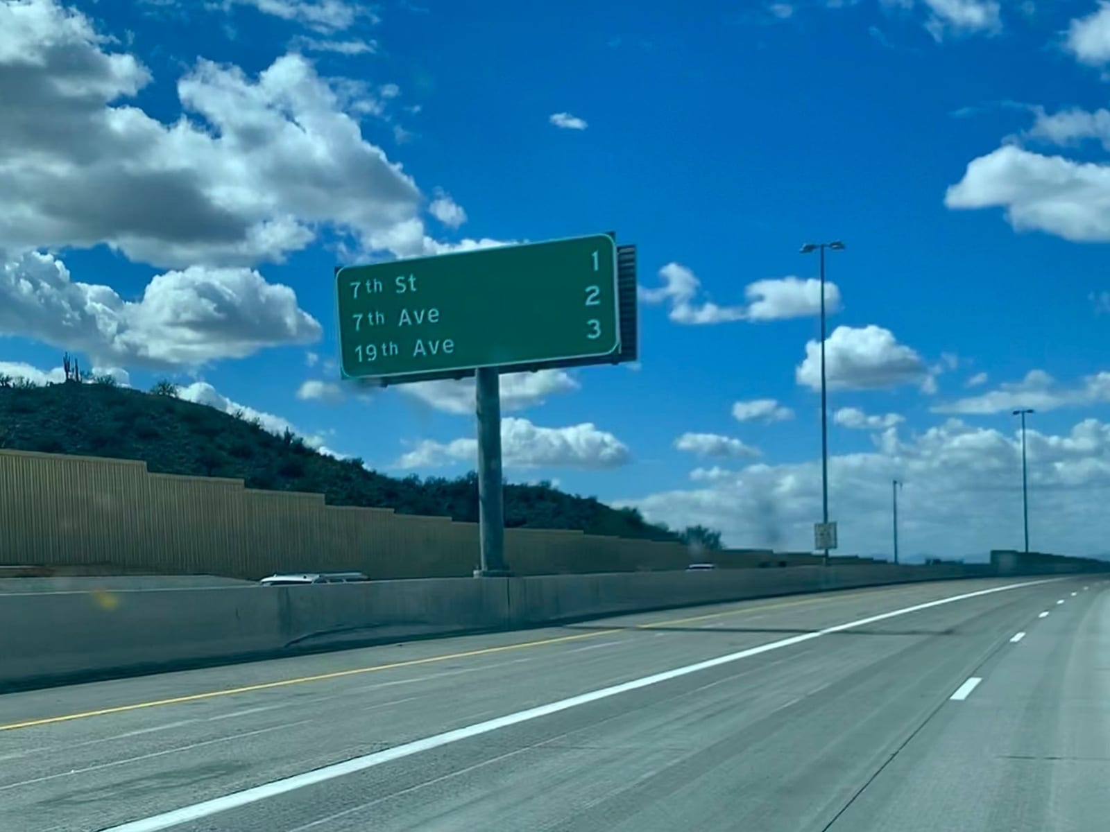An overhead green sign: 7th St 1, 7th Ave 2, 19th Ave 3.