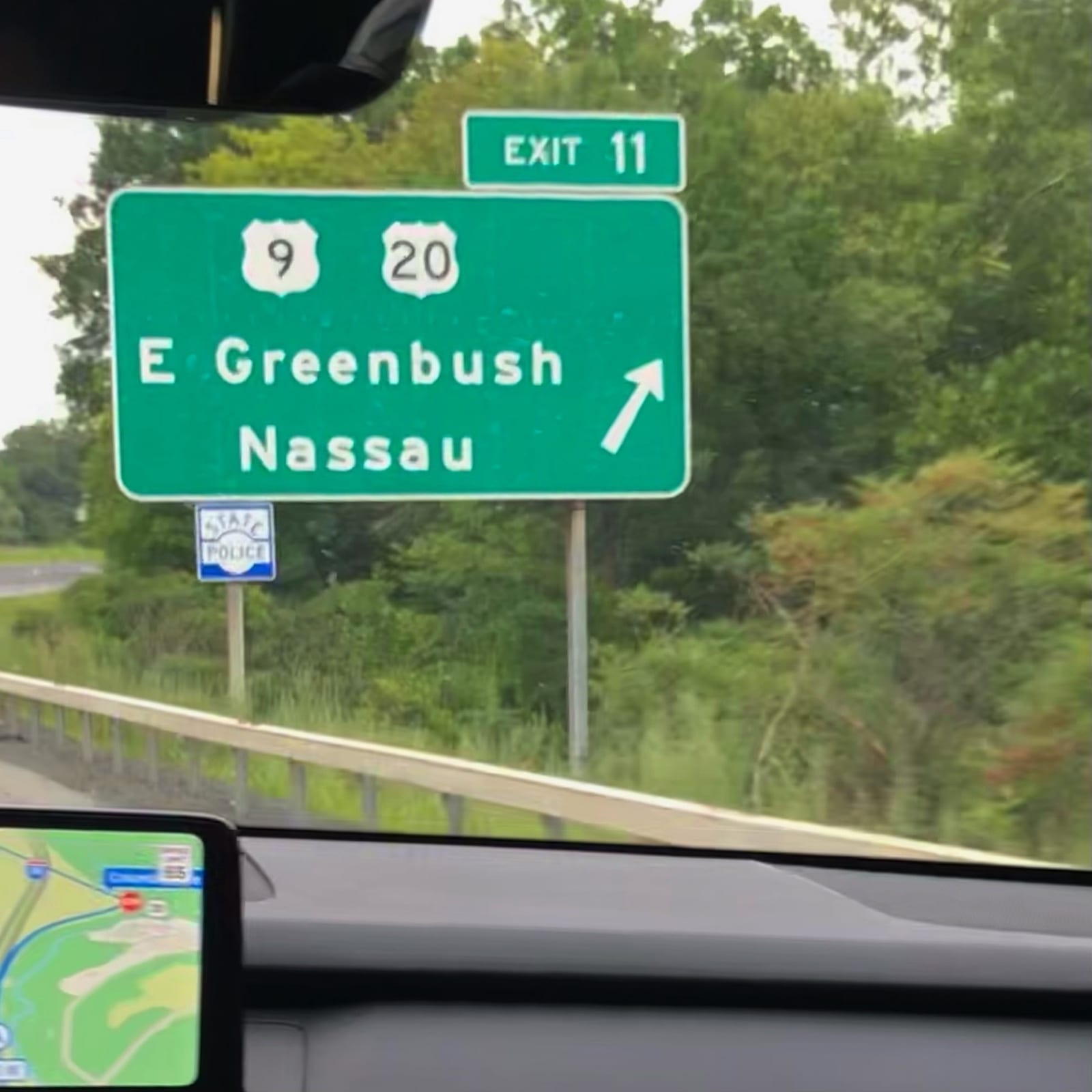 A green exit sign seen through a windshield: Exit 11, US 9 and US 20, E Greenbush and Nassau.